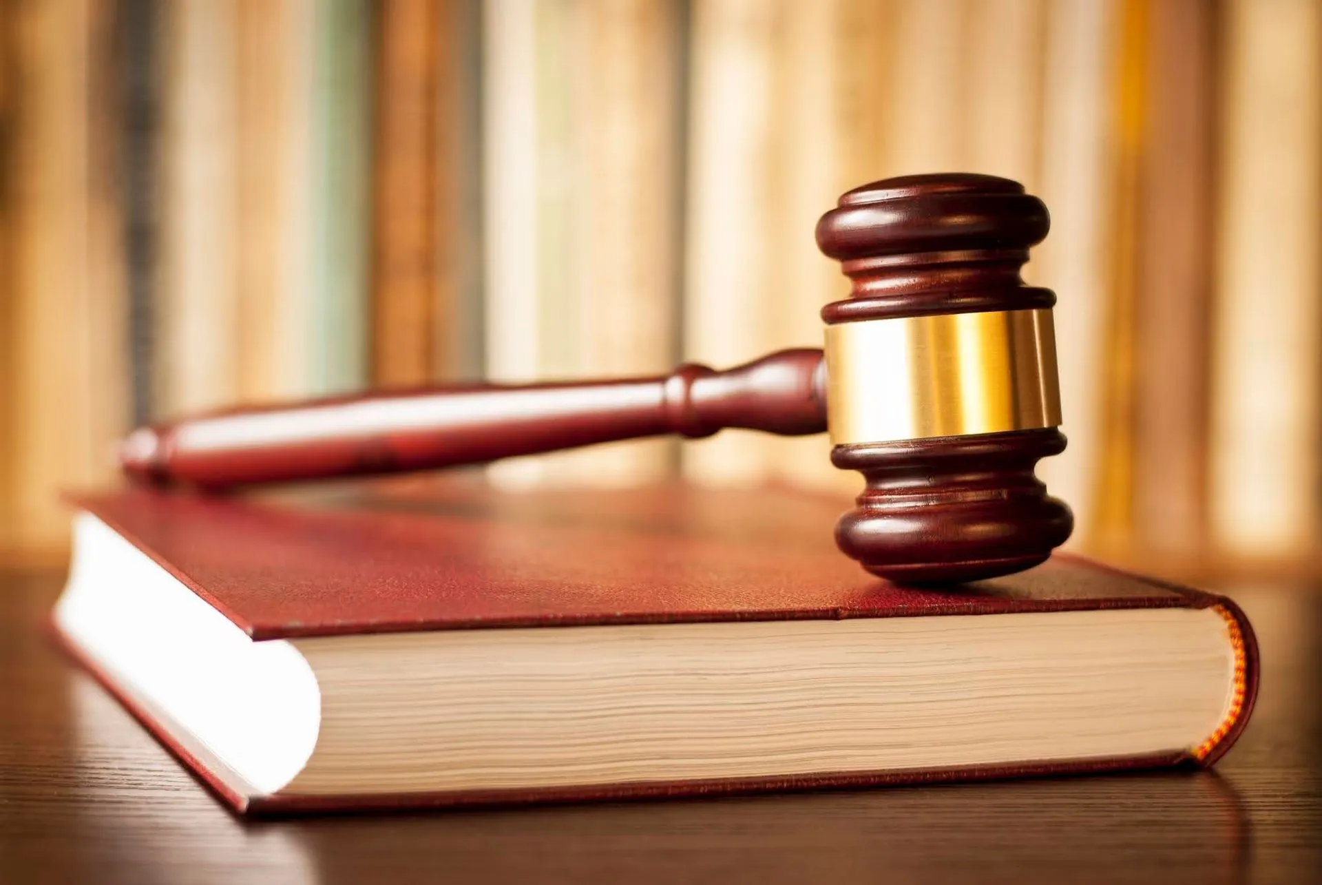 A wooden gavel resting on a law book.
