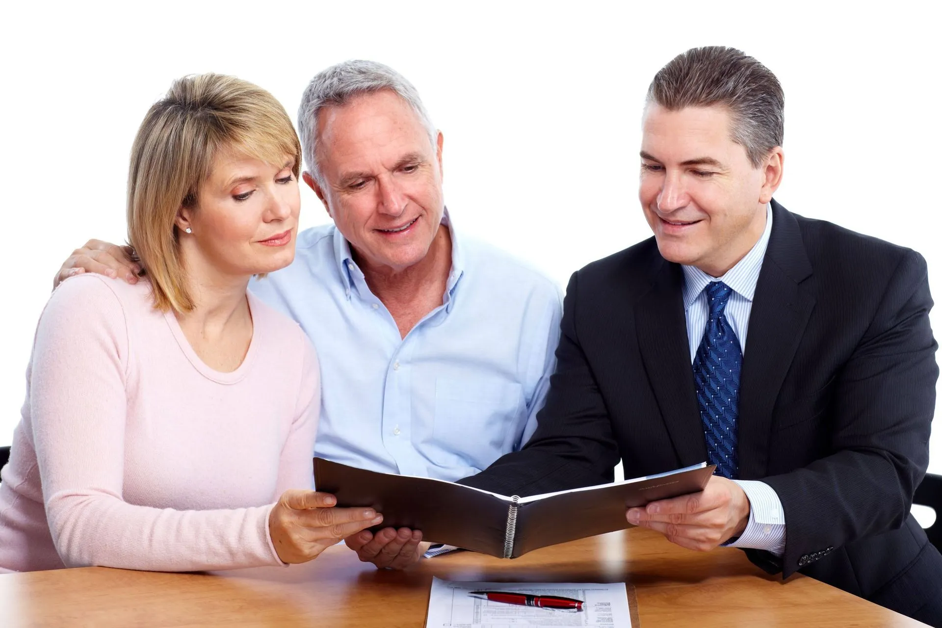 An older couple looking at a document with an advisor.