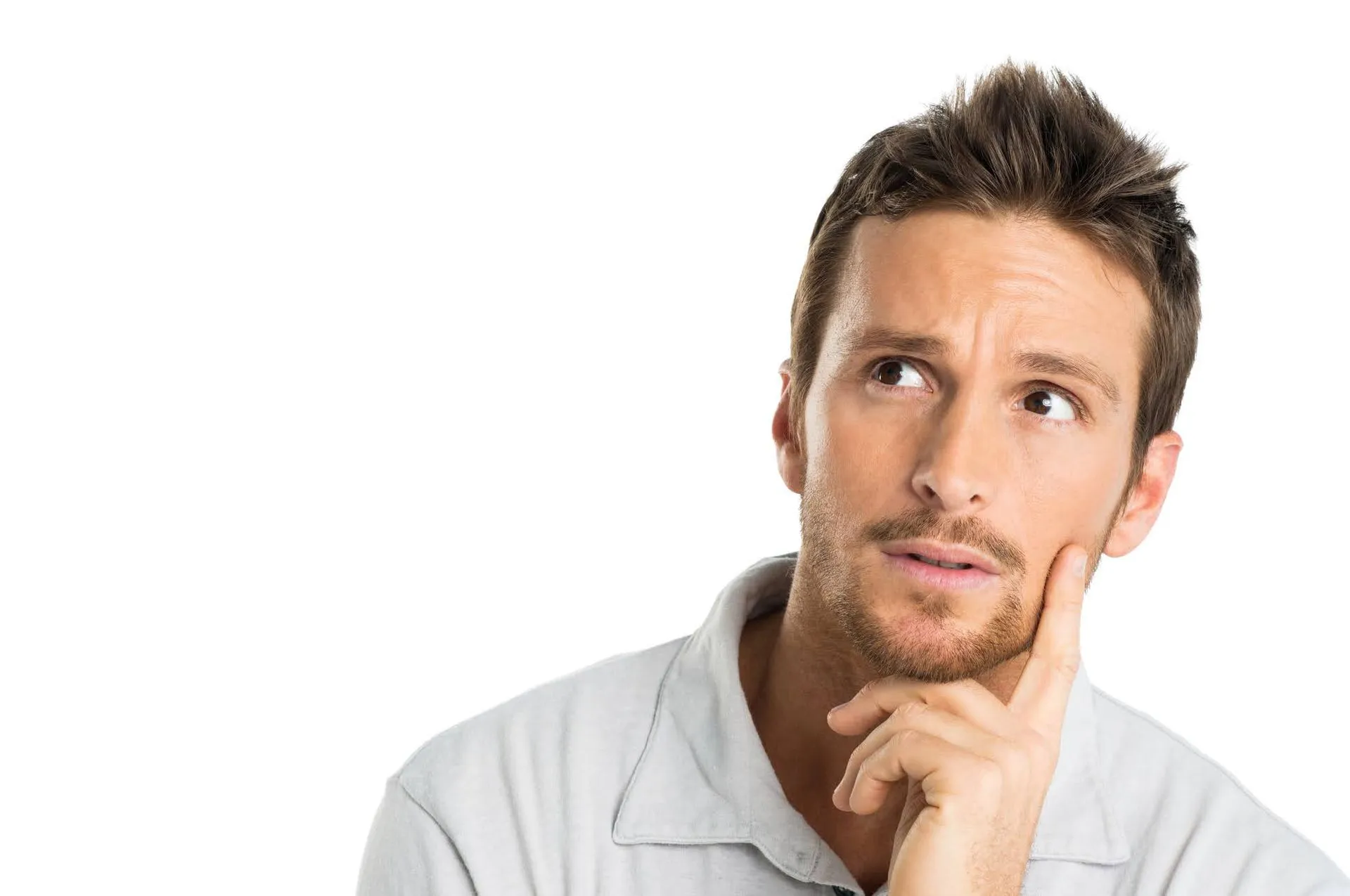 A thoughtful man looking up with a hand on chin.