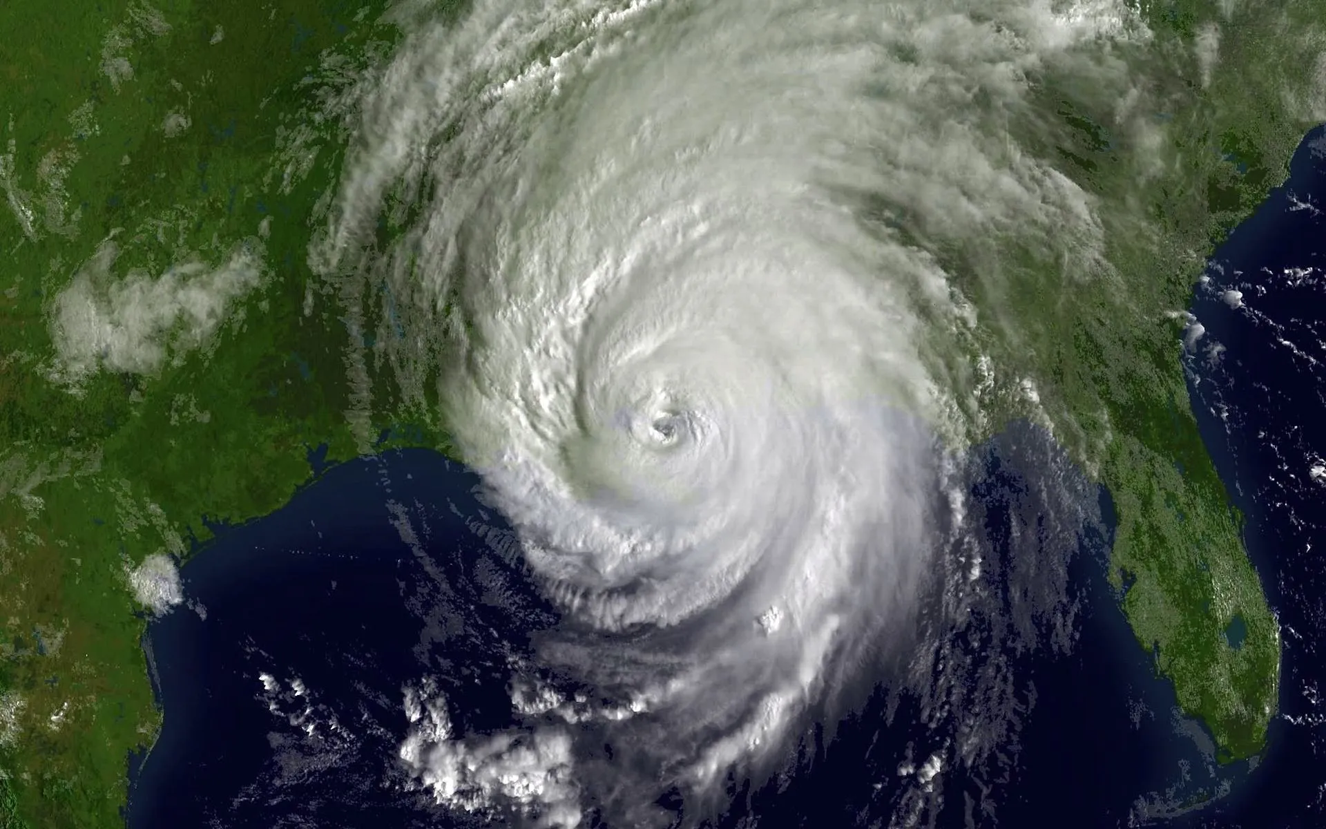 A satellite view of a large hurricane over land.