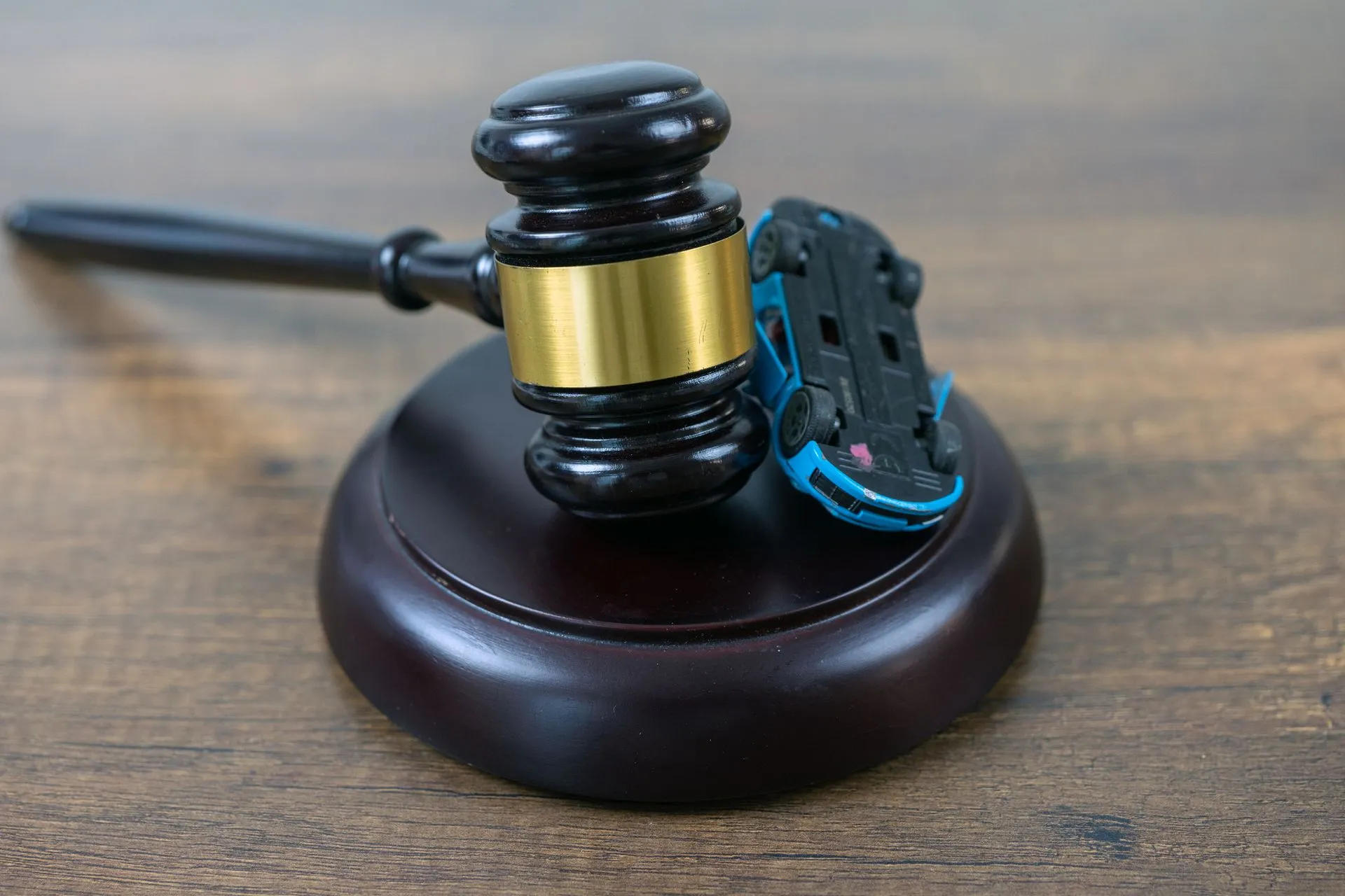 The gavel and car model represent a car accident lawsuit concept.