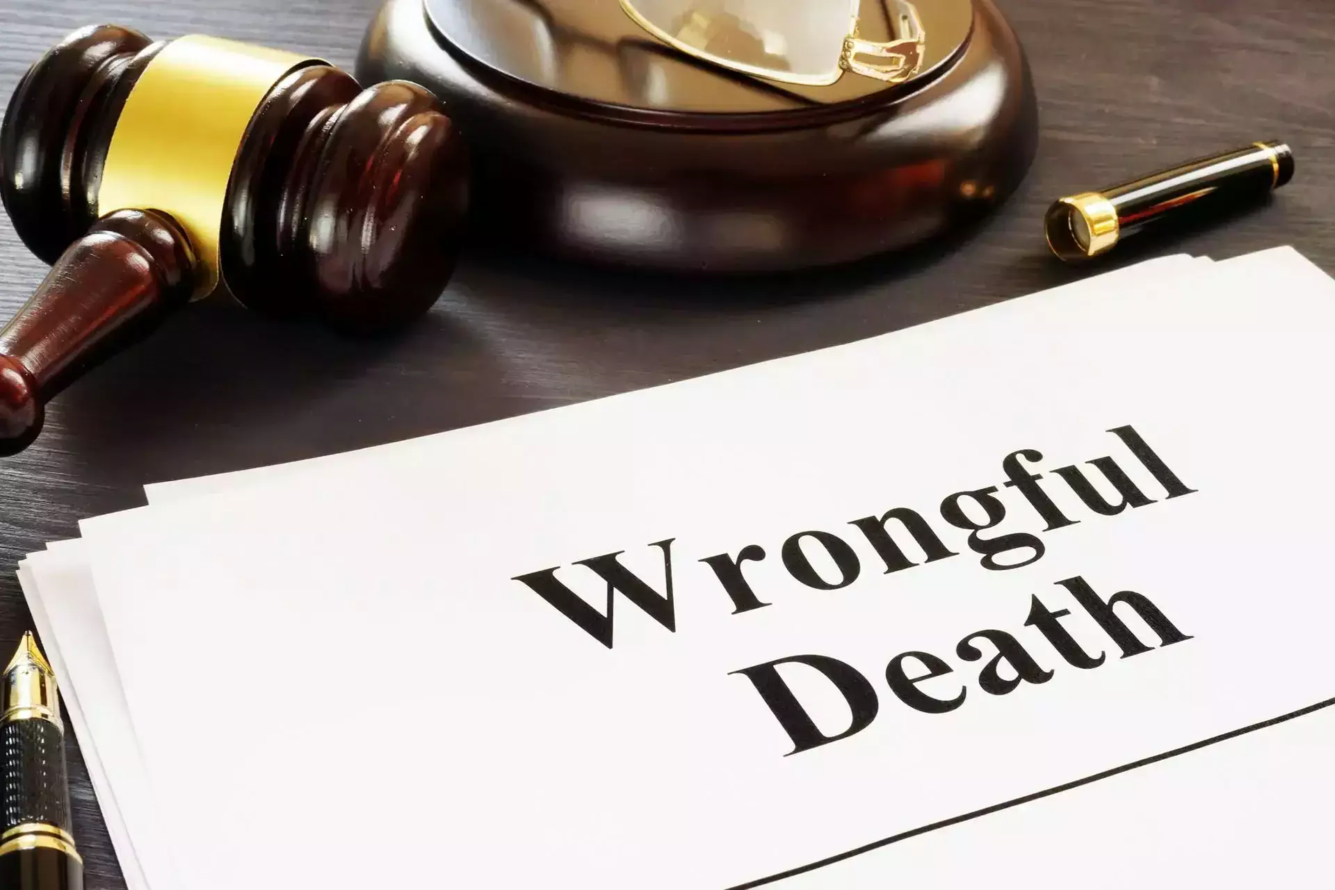 A judge's gavel next to a document titled 'Wrongful Death'.