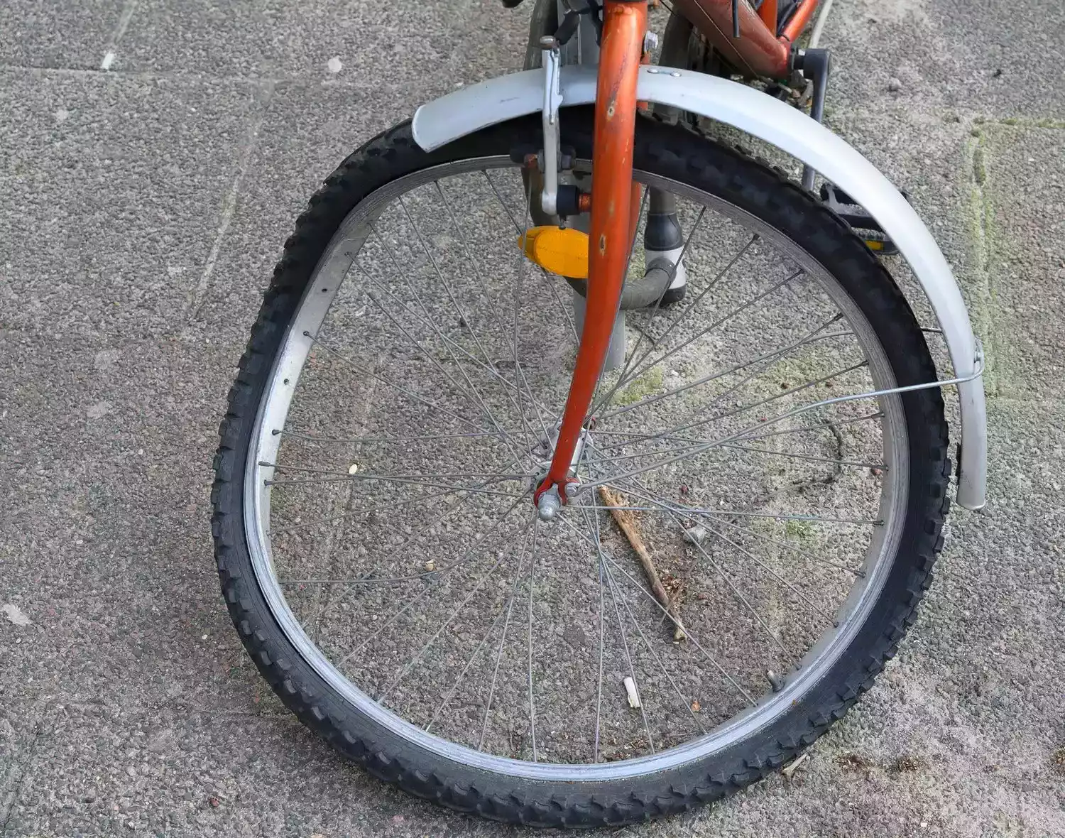 Damaged bicycle front wheel with bent spokes after an accident