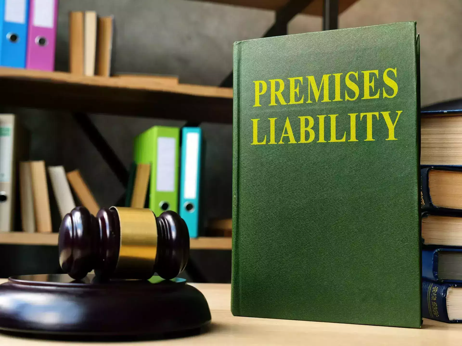 A green book titled 'Premises Liability' next to a gavel.