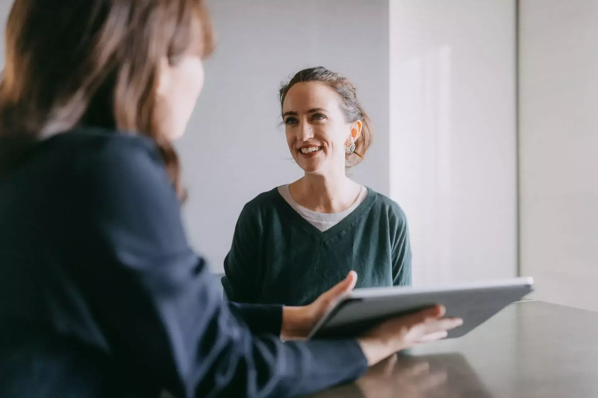 Woman speaking with a professional during an office consultation