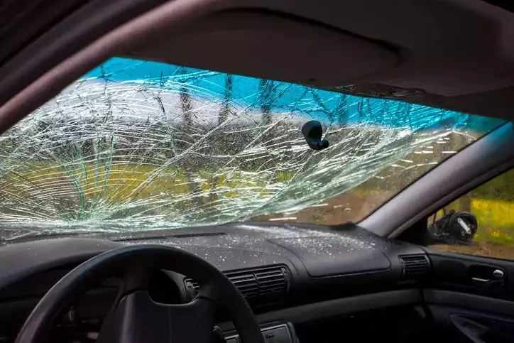 A shattered car windshield seen from the inside.