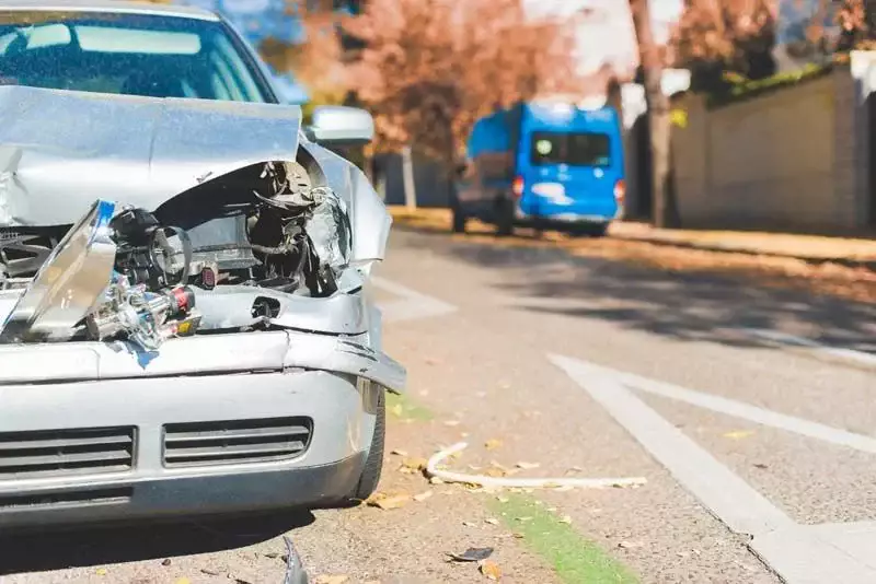 Severely damaged car on the roadside after a traffic accident.