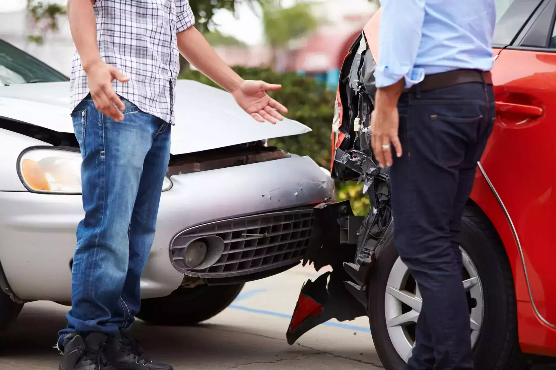 Two drivers discussing damage between their vehicles after a car accident