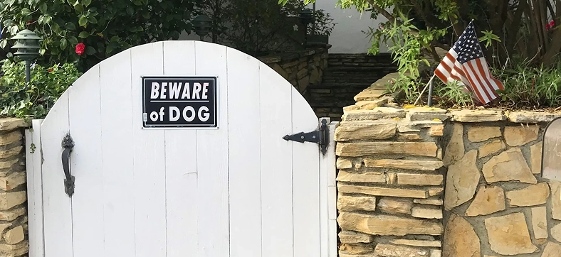 Beware of Dog warning sign displayed on a residential gate.