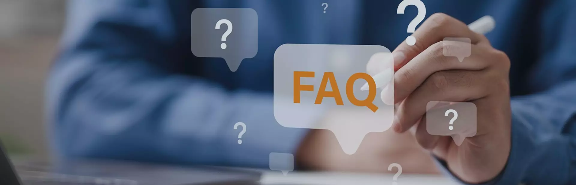 Person in blue shirt using stylus on tablet with floating FAQ and question mark icons around hand and device.